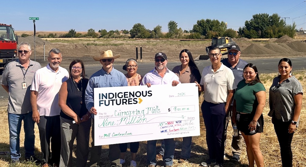 Native CDFIs and members of Cairnspring and MDF teams gather on the fields near the construction site of the mill. L–R: Bill Tovey, CTUIR Department of Economic & Community Development; Pete Upton, Native360 Loan Fund; Jamie Olson, Oweesta Corporation; Josey Steeples, Cairnspring Mills; Jordan Ruiz, Northwest Native Development Fund; Kevin Morse, Cairnspring Mills; Cassandra Waters, NNDF; Ted Piccolo, Mission Driven Finance; Dave Tovey, Nixyáawii Community Financial Services; Elizabeth Ferguson, NNDF; Jonelle Yearout, Nimiipuu Community Development Fund. (Photo courtesy of Mission Driven Finance)