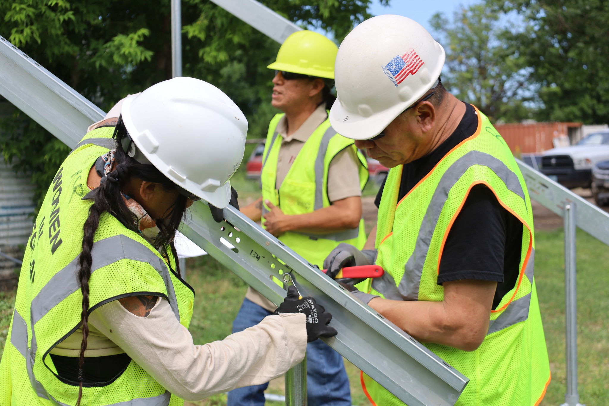 As federal clean energy funding disappears, tribes across the U.S. are launching workforce training programs to build internal capacity for renewable energy projects. From Maine to California, Native communities are training their own people as solar installers, energy auditors, and electricians to reduce dependence on external contractors and federal support. (Photo: Red Cloud Renewables)